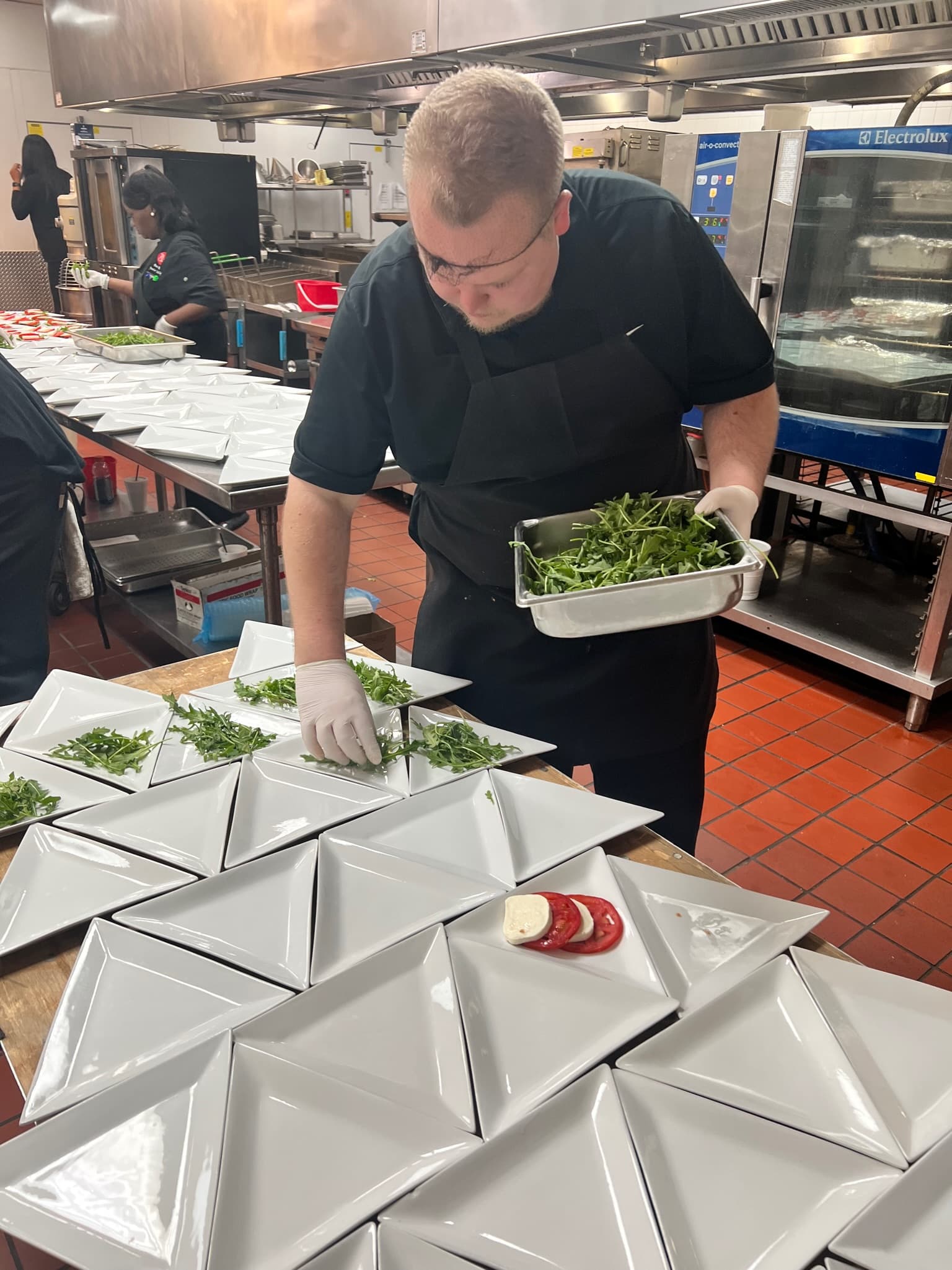 Croux talent prepping salad in commercial kitchen
